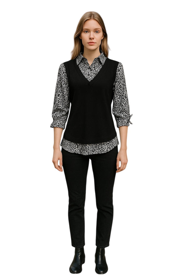 Grey and Black wearing a layered outfit, v-neck sweater vest over a patterned collared shirt.