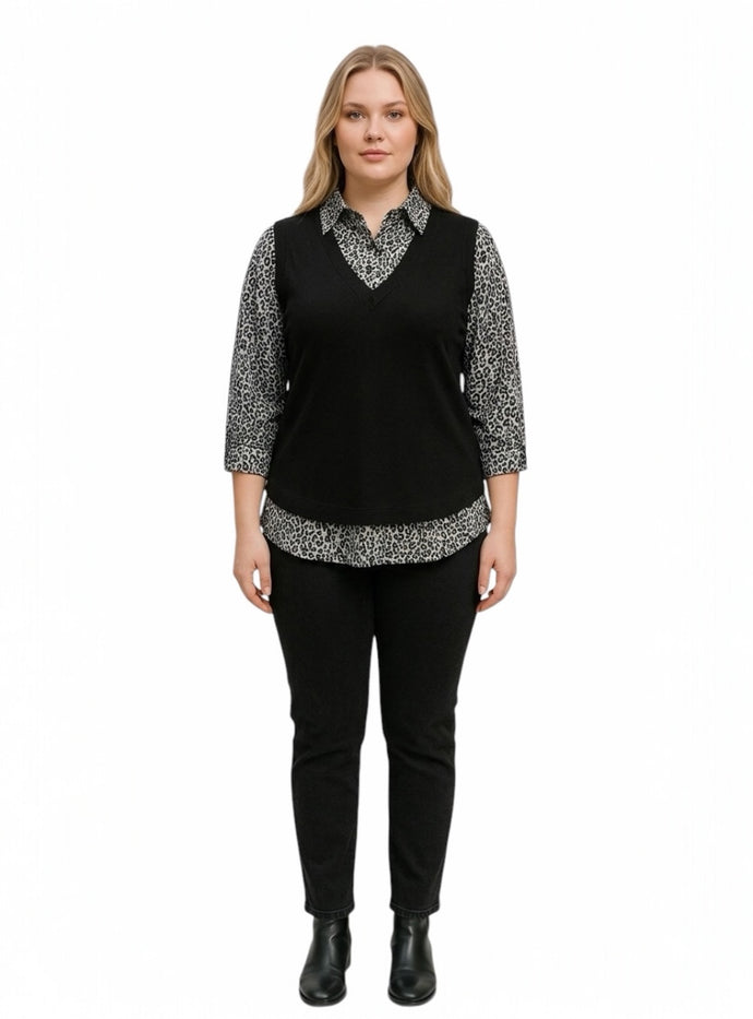Grey and Black wearing a layered outfit, v-neck sweater vest over a patterned collared shirt.